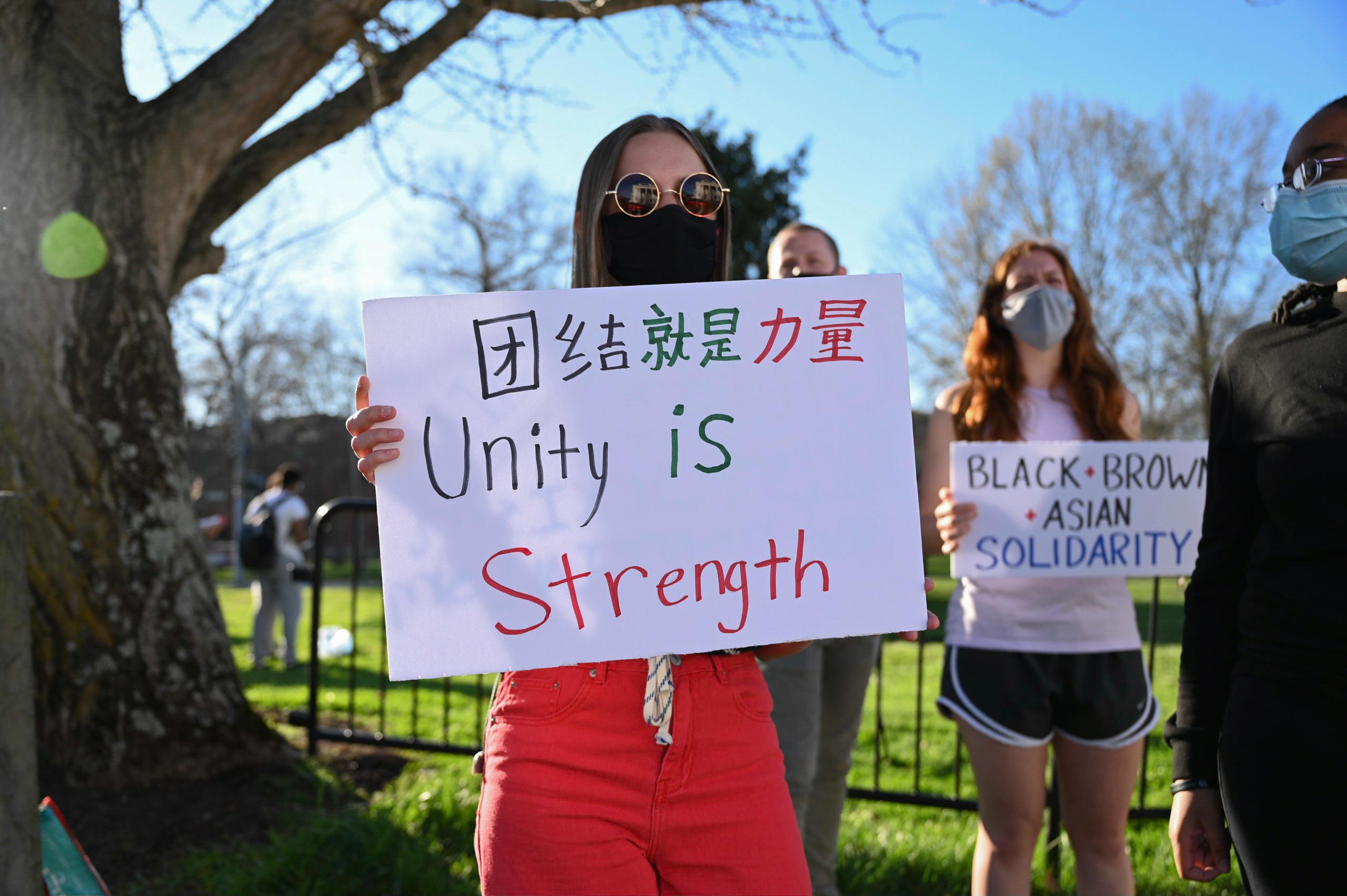 Berea College student holding a demonstration sign